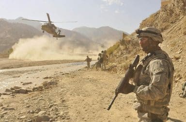 Afghanistan War trooper with gun in desert
