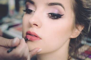 Beautiful woman having makeup put on her