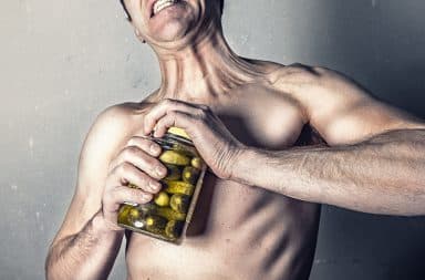 Strong man opening pickles