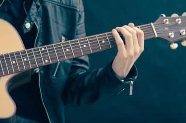 guy playing music on a guitar