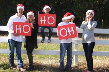 Santa hats on a fence outside