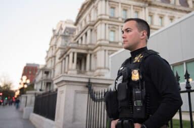 Secret Service armed guard with bulletproof vest